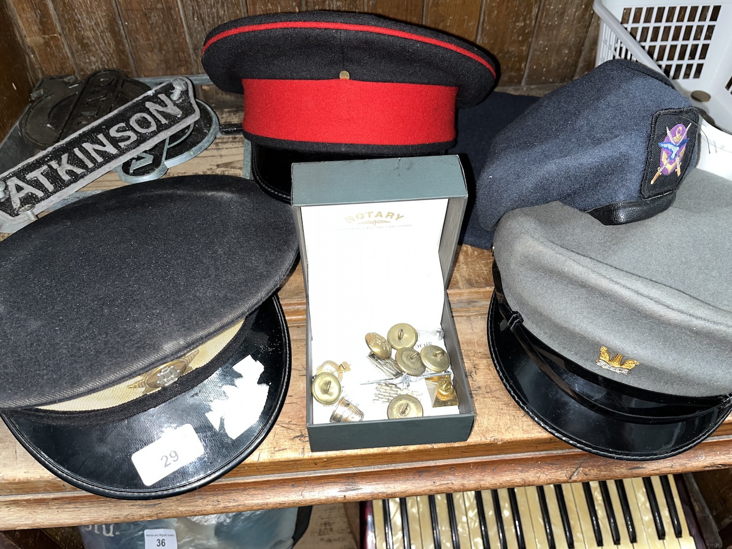 An RAF beret, a 14th Kings Hussar cap, a box containing Royal Horse Artillery brass buttons and