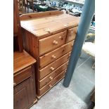 A pine chest of drawers.