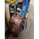 A golf bag with vintage clubs to include hickory shafted.