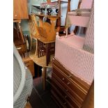 Various items of furniture; a chest of drawers, dining table and chairs, nest of tables, side