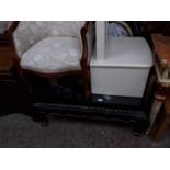 A Chinese coffee table, a modern tub chair and a white cheval mirror.