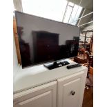 A 32" Samsung TV with remote.