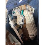 A large Kookaburra cricket bag with pads, bats and balls.