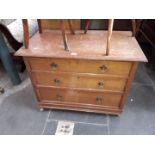 An oak chest of drawers.