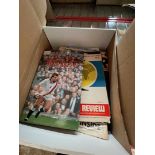 A box of sporting memorabilia including signed books by Rob Andrew and Peter Alliss.
