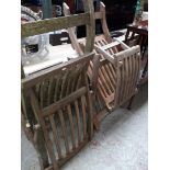 A pair of teak garden chairs.