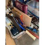 A box of games including poker chips, tennis / badminton rackets, Scrabble, a shooting stick, etc.