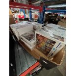 A box of Parisien scene jigsaw puzzles, sealed.