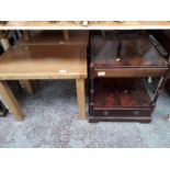 A reproduction mahogany occasional table, a light wood bedside cabinet and two light wood tables.