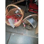 A basket of metalware including horse shoes, a jam pan and a cow bell