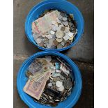 Two tubs of world coins and banknotes.