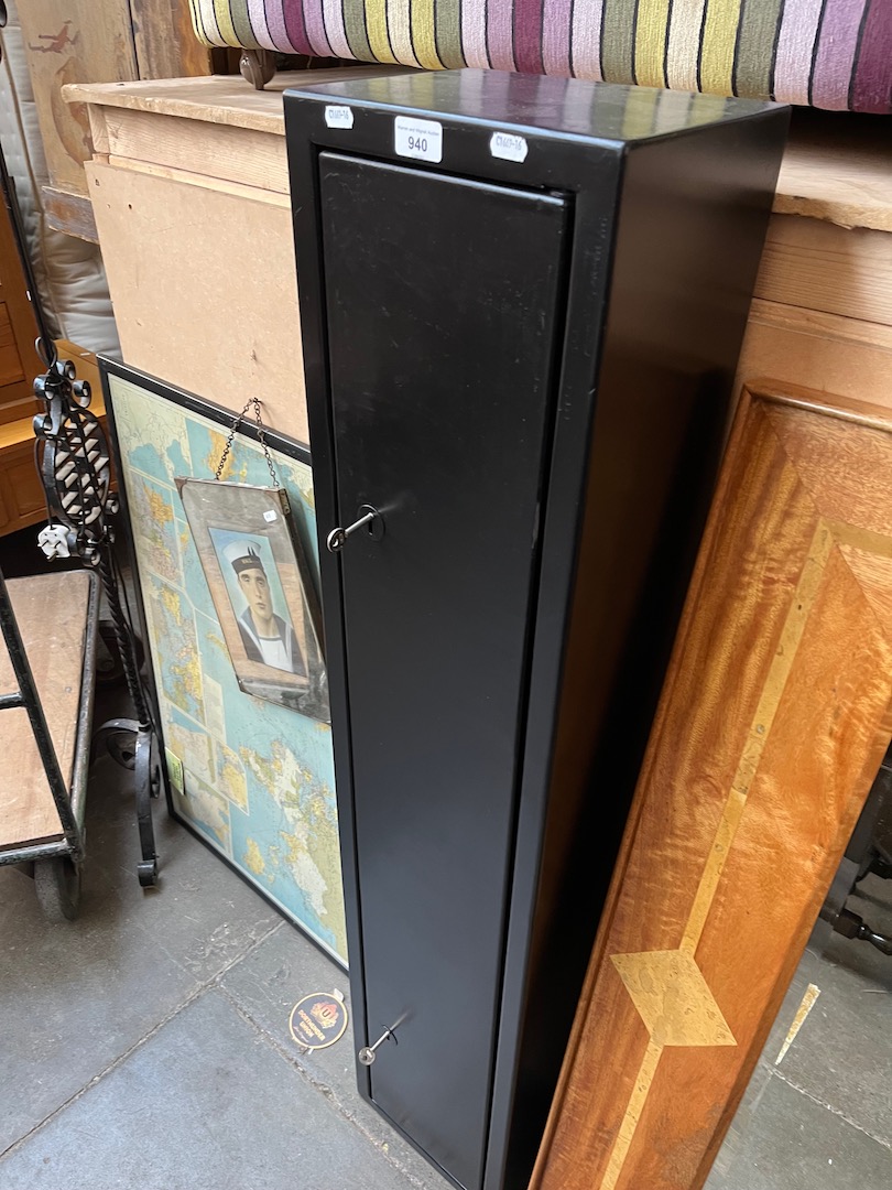 A metal gun cabinet with two keys.