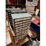 Three multi-drawer cabinets containing various electrical components.