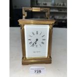 A Mappin & Webb gilt brass carriage clock with key.