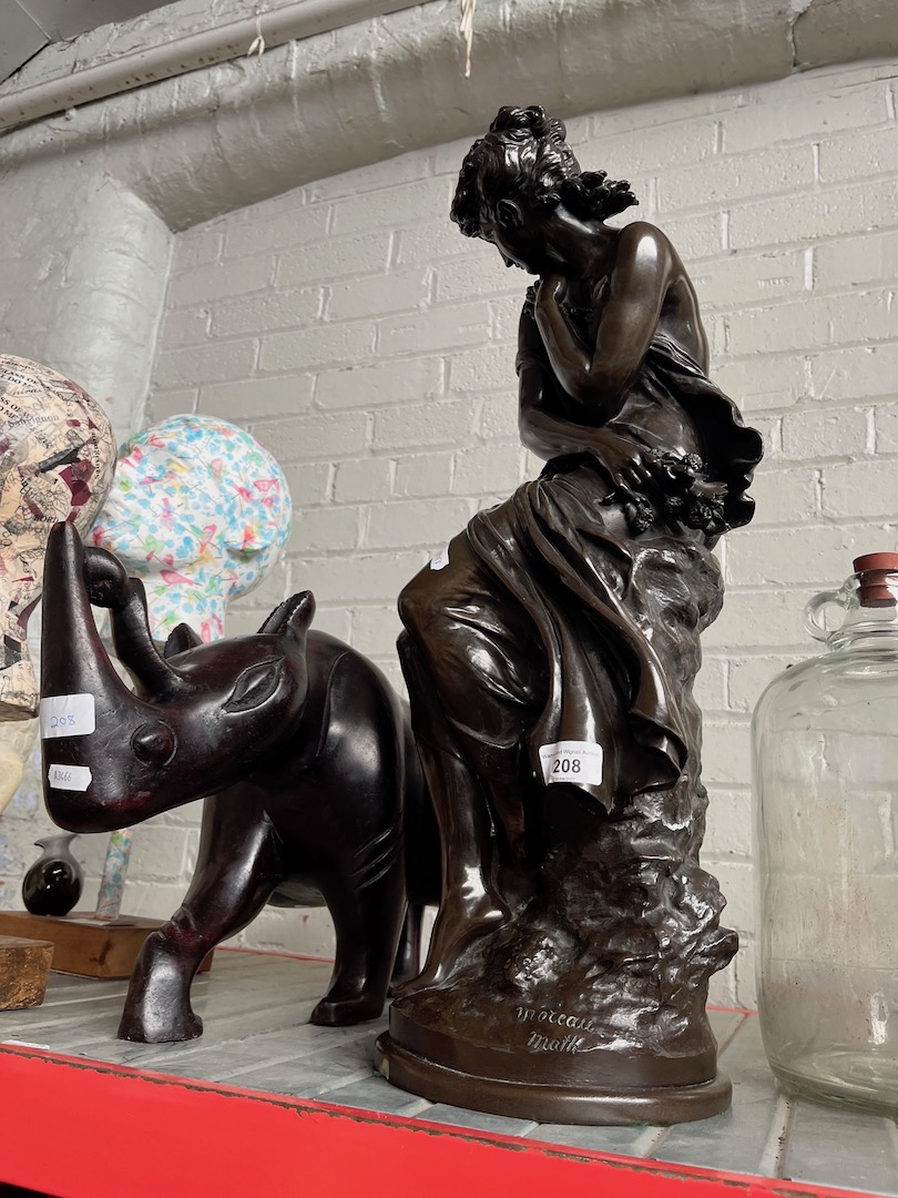 A repro statue of a young lady after Math. Moreau, and a large wooden rhino