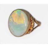 A precious opal cabochon ring, the bezel set opal measuring approx. 17.34mm x 14.41mm and depth 4.