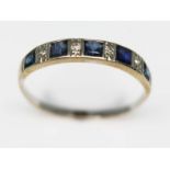 A diamond and sapphire half hoop ring, unmarked, gross wt. 1.8g, size U. Condition - evidence of