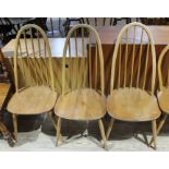 An Ercol blonde elm and beech drop leaf table and three chairs.