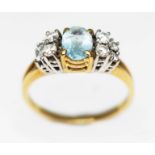 An aquamarine and diamond ring, the central oval cut stone weighing approx. 0.62ct, band marked '