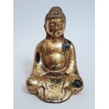A 19th century Thai gilt bronze seated buddha, height 17cm.