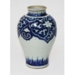 An oriental blue and white porcelain vase, possibly transitional period, decorated with floral