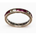 An antique white sapphire and ruby full eternity ring, engraved outer edge, channel set princess cut