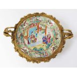 A Chinese Canton dish, 19th century, decorated in over enamels with central panel depicting