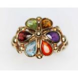 A hallmarked 9ct gold multi-gemstone ring, the cluster measuring approx. 16mm in diameter, gross wt.