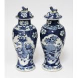 A pair of Chinese blue and white porcelain vases and covers, circa 1900, each bearing four character