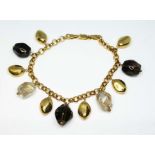 A 9ct gold bracelet, with pebbles of rutilated quartz, smokey quartz, length 18.5cm, gross wt. 18.
