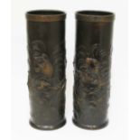 A pair of Chinese bronze stick stands, each decorated in relief with carp, 20th century, impressed