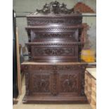 A large carved oak dresser with tiered back, circa 1900, width 155cm, depth 60cm & height 250cm.