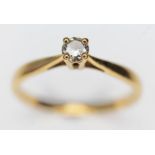 A diamond solitaire ring, the round brilliant cut diamond weighing approx. 0.07ct, band with