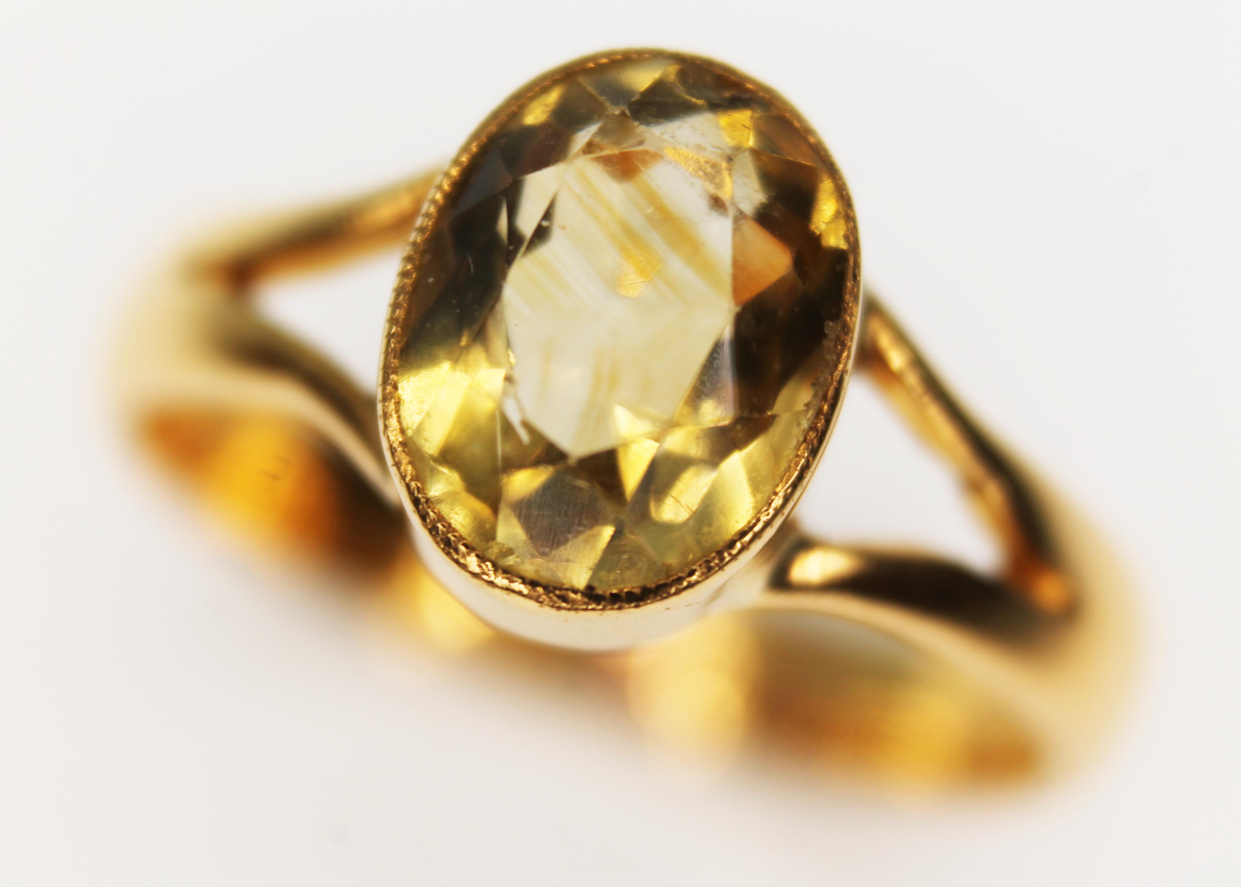 An antique solitaire ring, the oval cut citrine weighing approx. 2ct, band unmarked, gross wt. 6.6g,