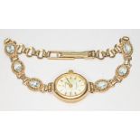 A ladies hallmarked 9ct gold Sovereign wristwatch, the hallmarked 9ct gold strap set with six blue