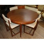 A mid 20th century teak extending dining table and four chairs, diameter 122cm.