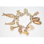 A hallmarked 9ct gold charm bracelet comprising Blackpool Tower, a carriage, a pair of slippers,