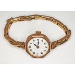 A hallmarked 9ct gold ladies wristwatch with strap marked '9ct', gross wt. 18.3g.