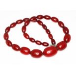 A marbled cherry bakelite graduated bead necklace, the beads ranging in length from 10mm to 22mm,