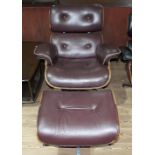 A burgundy lounge chair and matching footstool after Charles & Ray Eames.