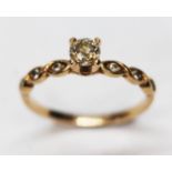 A diamond solitaire ring, diamond set shoulders, band unmarked, gross wt. 2.1g, size N.