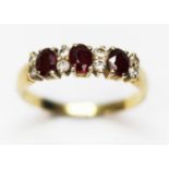 A hallmarked 18ct gold diamond and ruby cluster ring, gross wt. 2.8g, size O.