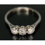An early 20th century three stone diamond ring, the round cut stones weighing approx. 0.21, 0.29 &