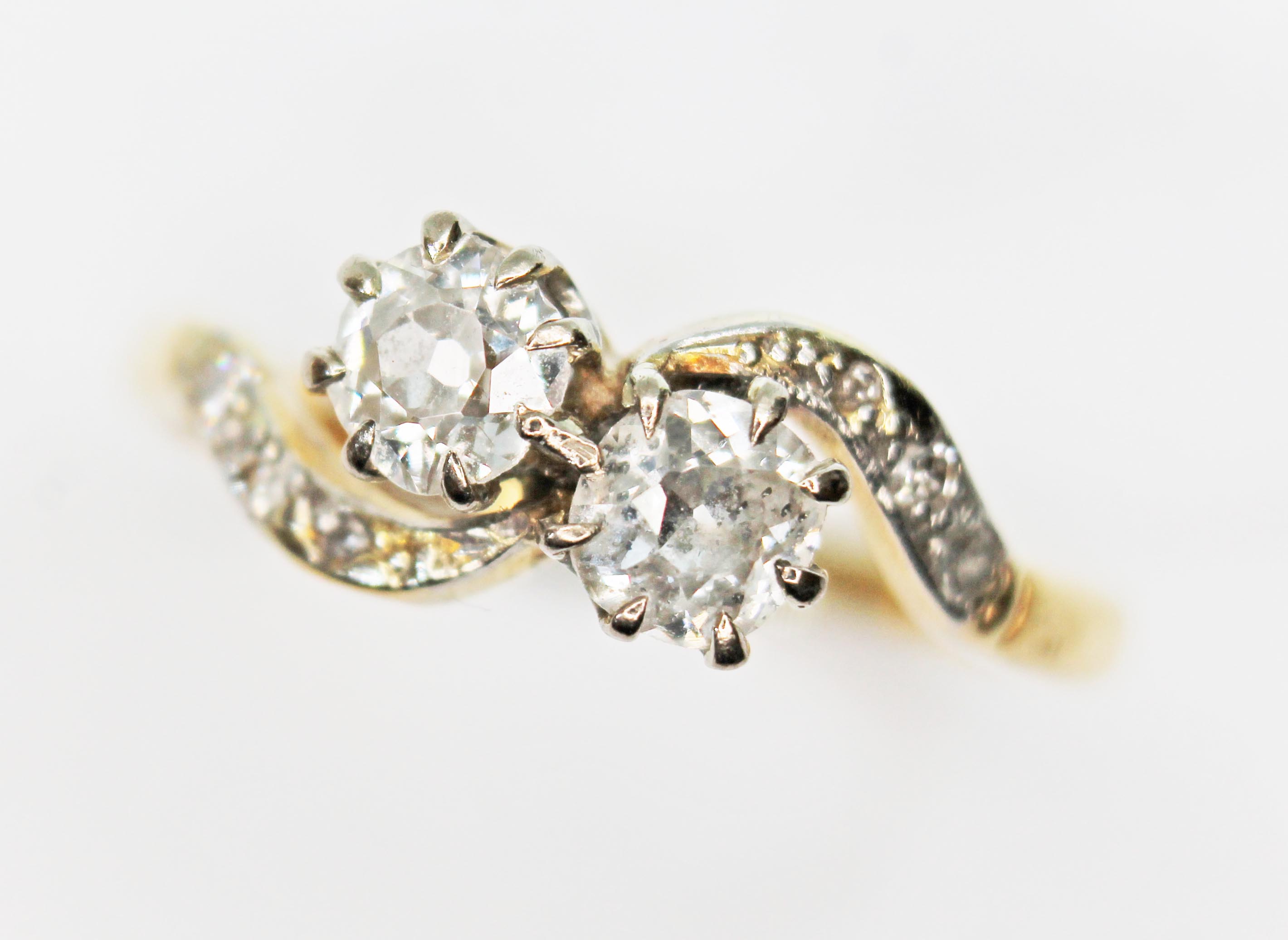 A diamond crossover ring, the two old Eurpoean cut diamonds weighing approx. 0.30 carats each,