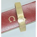 A ladies 18ct gold Omega wristwatch, signed gold dial with gold and black baton hour markers,