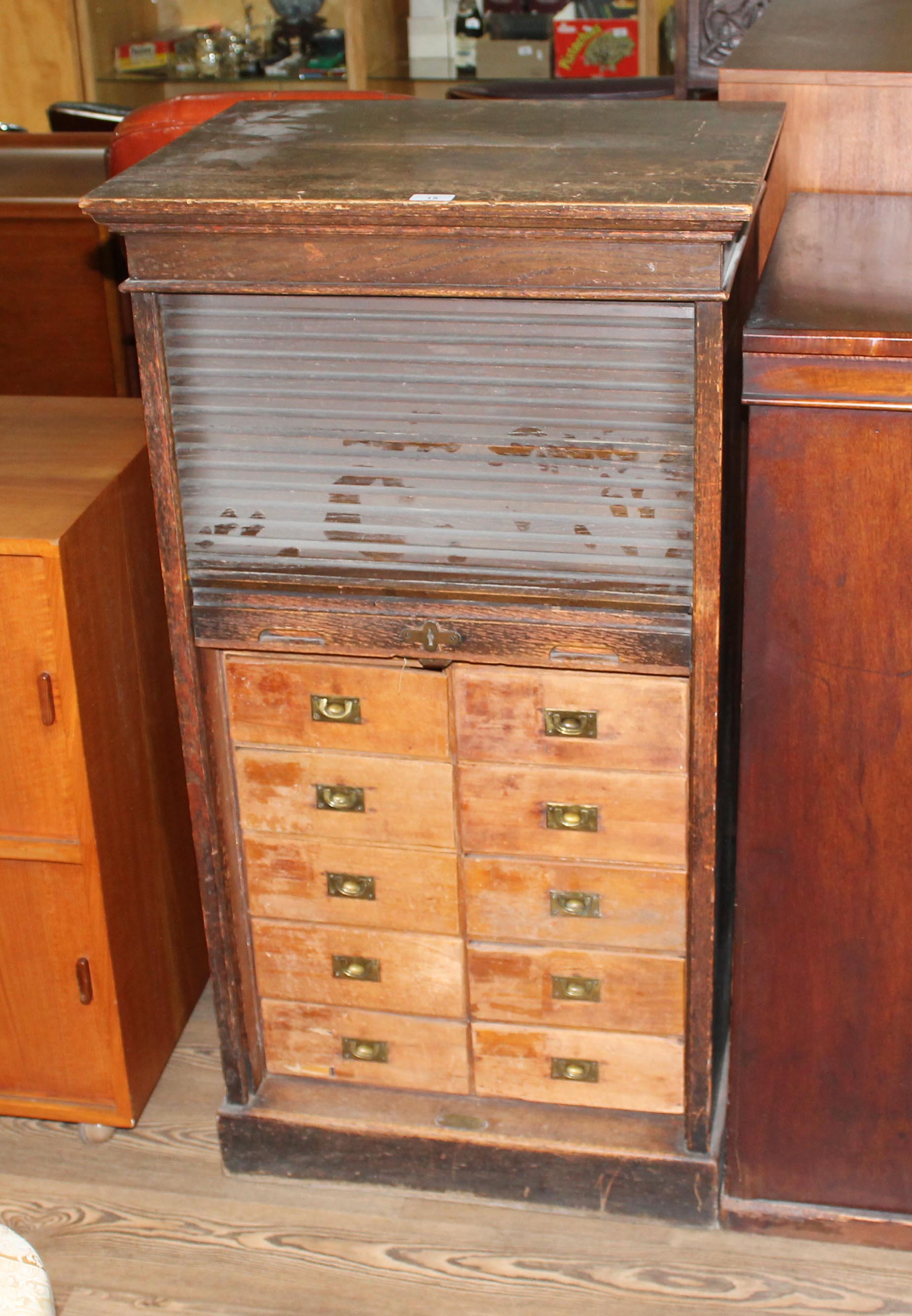 An early 20th century oak tambour fronted filing cabinet/ chest of drawers, height 115.5cm.