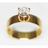 A CZ solitaire ring, the band marked '18CT', gross wt. 4.5g, size O.