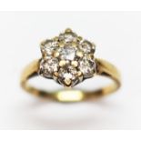 A diamond cluster ring, the seven stones weighing approx. 1ct in total, band marked '18K', gross wt.
