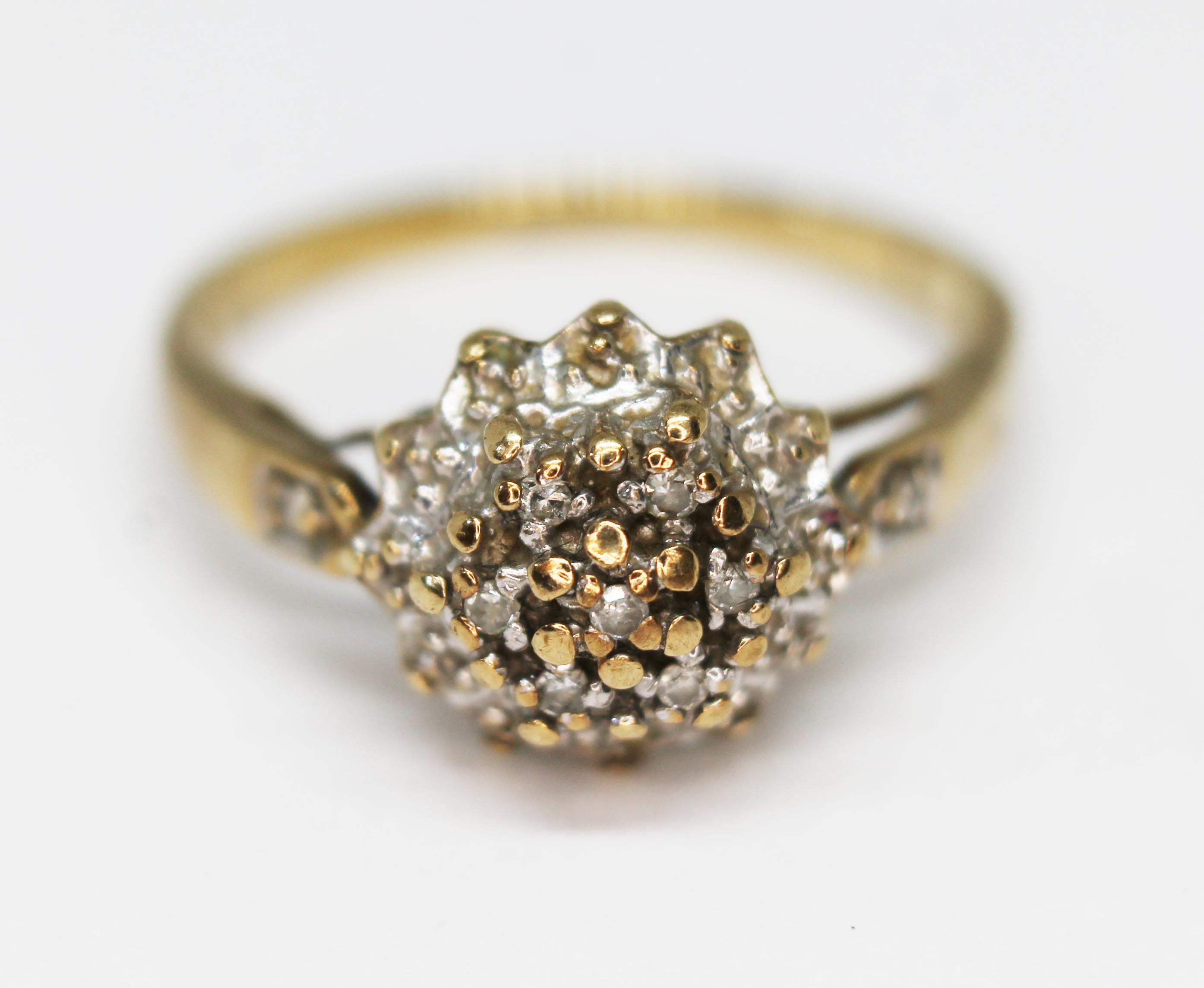 A hallmarked 9ct gold diamond cluster ring, gross wt. 2.2g, size M.