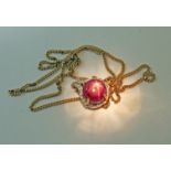 A synthetic star ruby and diamond pendant, marked '9K', on 44cm chain marked '375', gross wt. 5.2g.